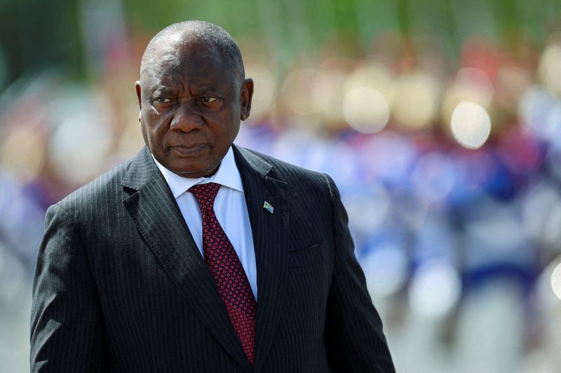 South Africa's President Cyril Ramaphosa reviews an honour guard while meeting Brazil's President Luiz Inacio Lula da Silva.