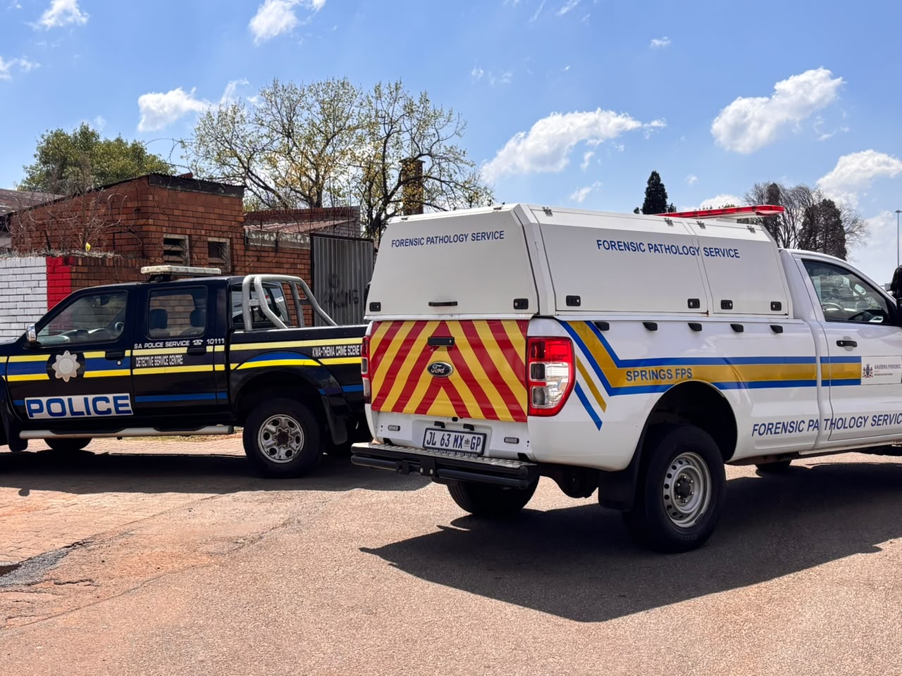 Police and forensic officials at the KwaThema scene where a woman’s body was discovered.